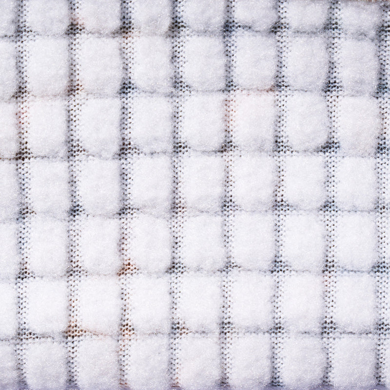 | so_fuzzy_n_warm.JPG | A close-up of a white textured fabric with a subtle gray grid pattern.