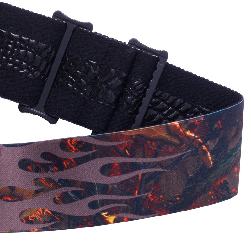 / Red | its_a_strap.JPG | Close-up of a goggle strap with a black textured webbing strap and a camouflage-style flame pattern in brown, black, and orange.
