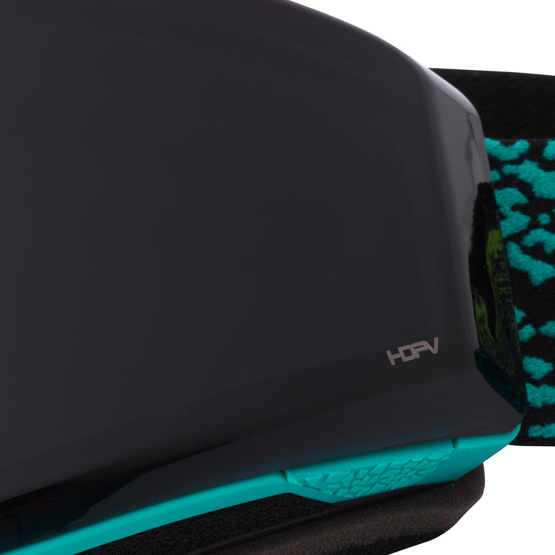 HDPV Smoke | im_ready_for_my_closeup.JPG | Close-up of ski goggles showing a dark gray lens, a bright teal textured lower edge, and a black strap with a teal pattern. The wordmark 'HDPV' is visible on the lens.