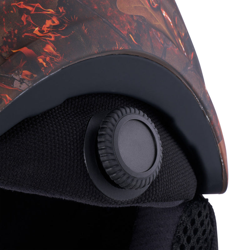  | im_ready_for_my_closeup.JPG | Close-up of a helmet interior showing a black adjustable ventilation valve, textured black padding, and a red and black flame-patterned shell against a white background.
