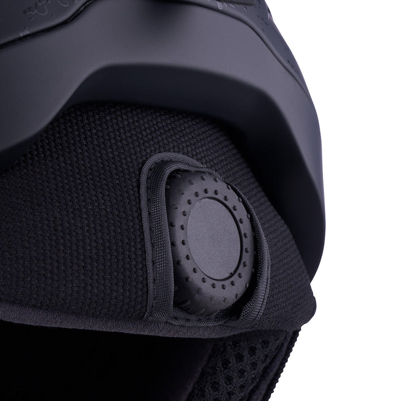 | dial_up.JPG | Close-up of a black protective helmet with a breathable mesh interior and a circular ventilation or adjustment vent on the side, shown against a white background.