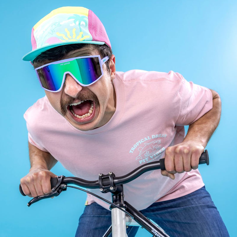  | photo_of_person.JPG | Man rides bike wearing The Moontower Try-Hard from Pit Viper Sunglasses