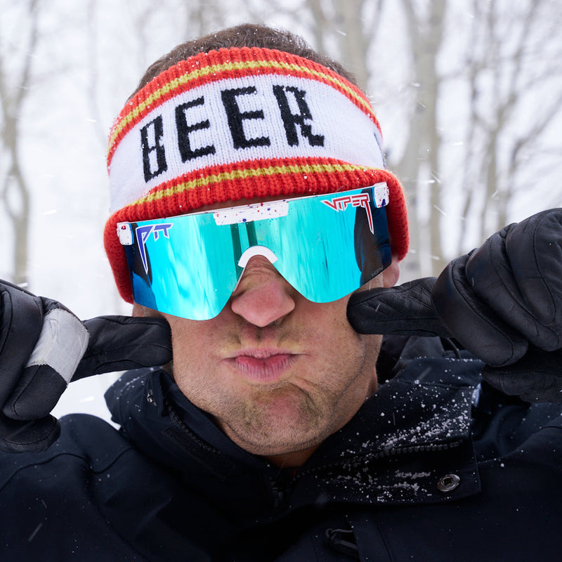  | photo_of_nick_g.JPG | Nick Goepper wearing the Beer Half Hat in a forest in the snow while puffing his cheeks.