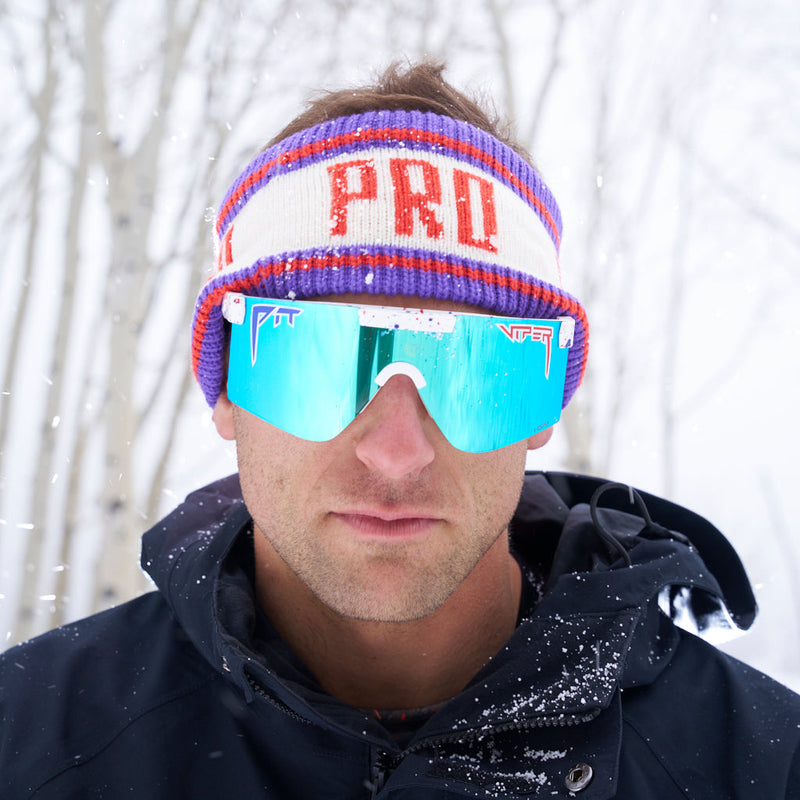 | photo_of_nick_g.JPG | Nick Goepper making a serious face while wearing the Pro Half Hat Headband from Pit Viper in the snowy forest.