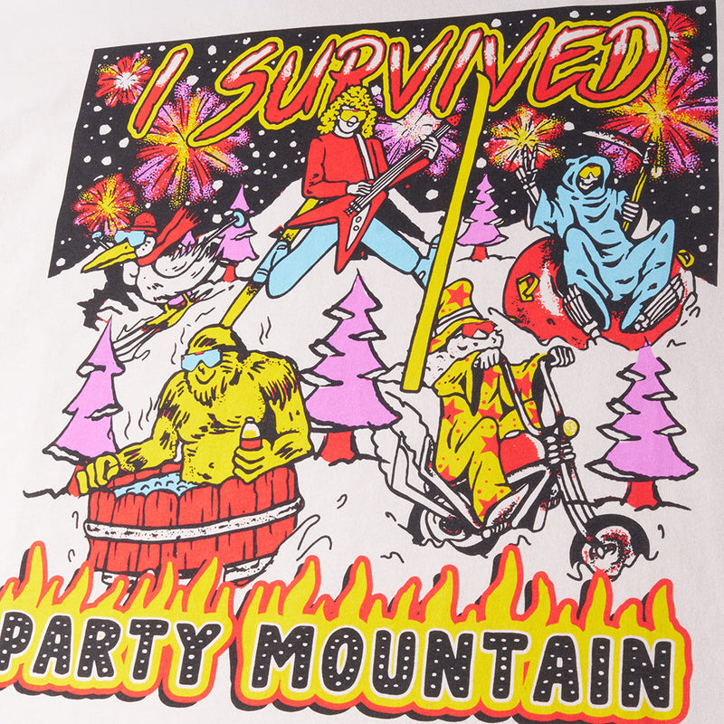 | im_ready_for_my_closeup.JPG | A close-up of a graphic t-shirt print featuring a colorful cartoon illustration with the text 'I SURVIVED PARTY MOUNTAIN'. The graphic shows a person in a red jacket playing a red guitar, a blue ghost-like figure, a yellow figure in a bathtub, and pink Christmas trees on a black background with white stars.