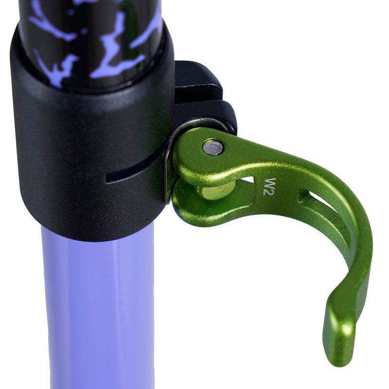 Close-up of a green metal adjustment clamp attached to a black clamp on a purple pole, shown against a white background.