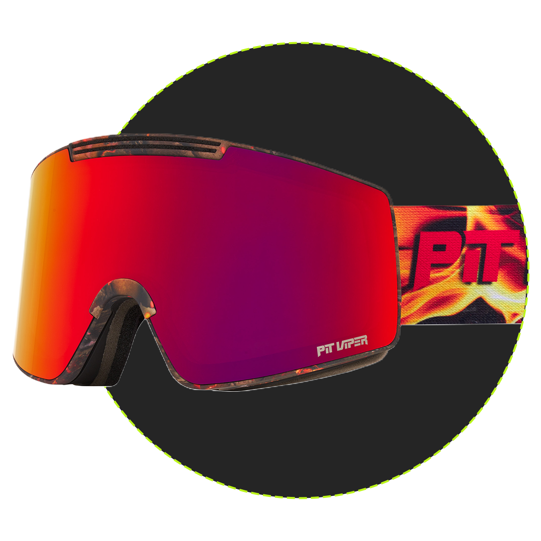 Goggles with a large mirrored red-to-purple lens, black frame, and a flame-patterned strap with bold red 'PT' lettering, shown on a dark circular background.