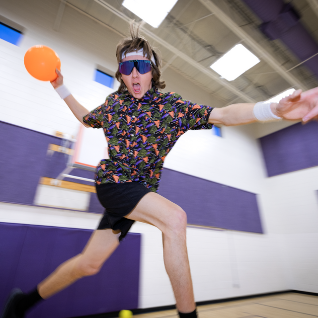 Photo of man playing dodgeball in a gym wearing the sport beer tear away button down shirt from pit viper.