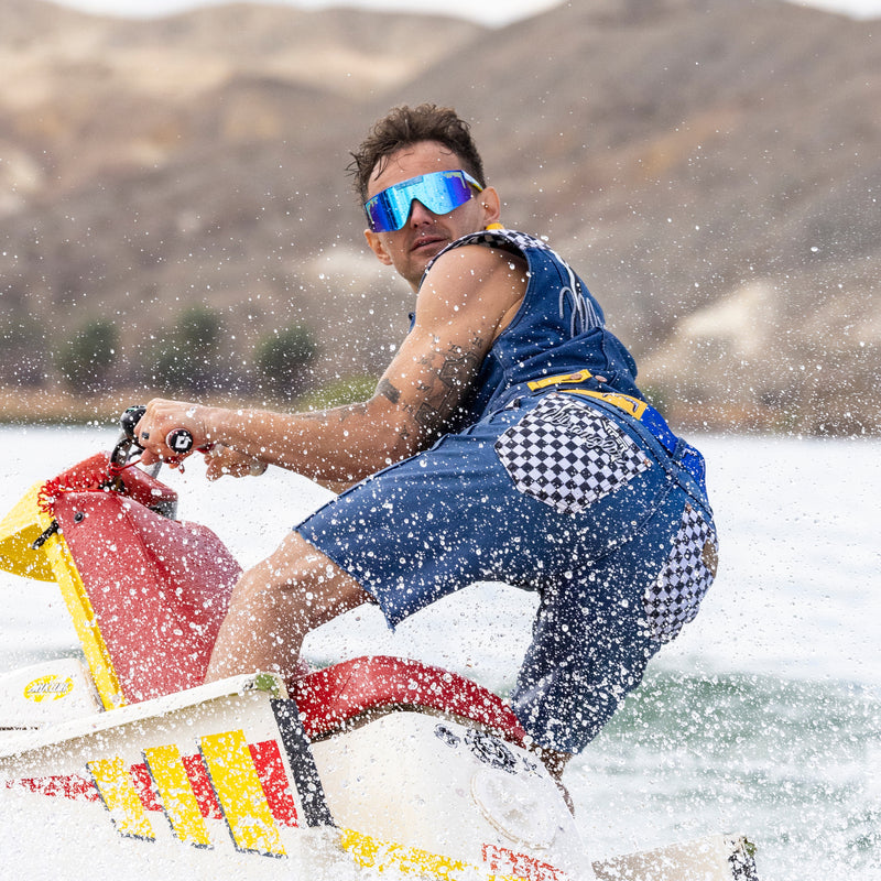 Person water skiing on a lake with mountains in the background