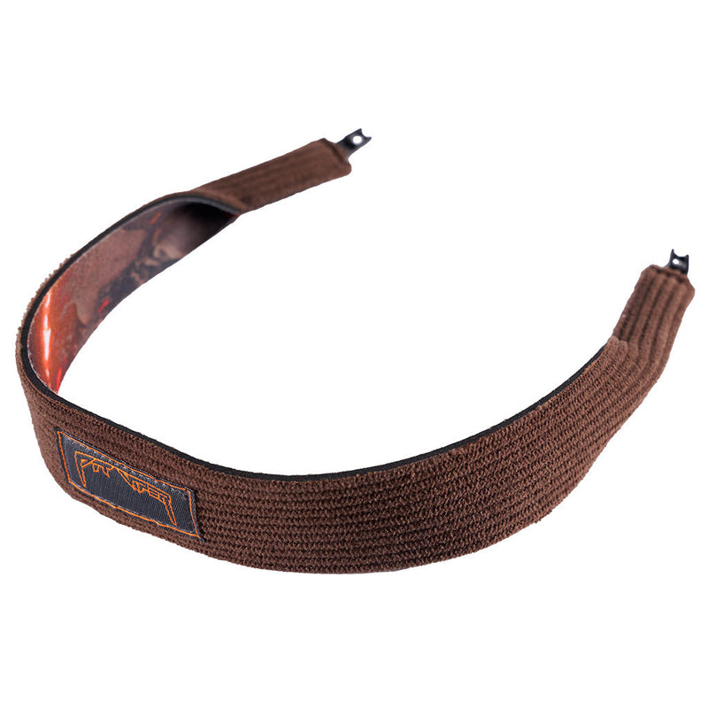 | side_view.JPG | A brown textured fabric sunglasses strap with a camouflage-patterned inner lining and a small rectangular brand patch on the front, shown against a plain white background.