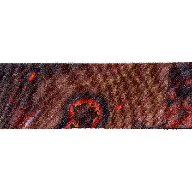 | inferno.JPG | A close-up horizontal view of a woven textile or strap featuring an abstract pattern in dark brown, black, red, and beige tones.