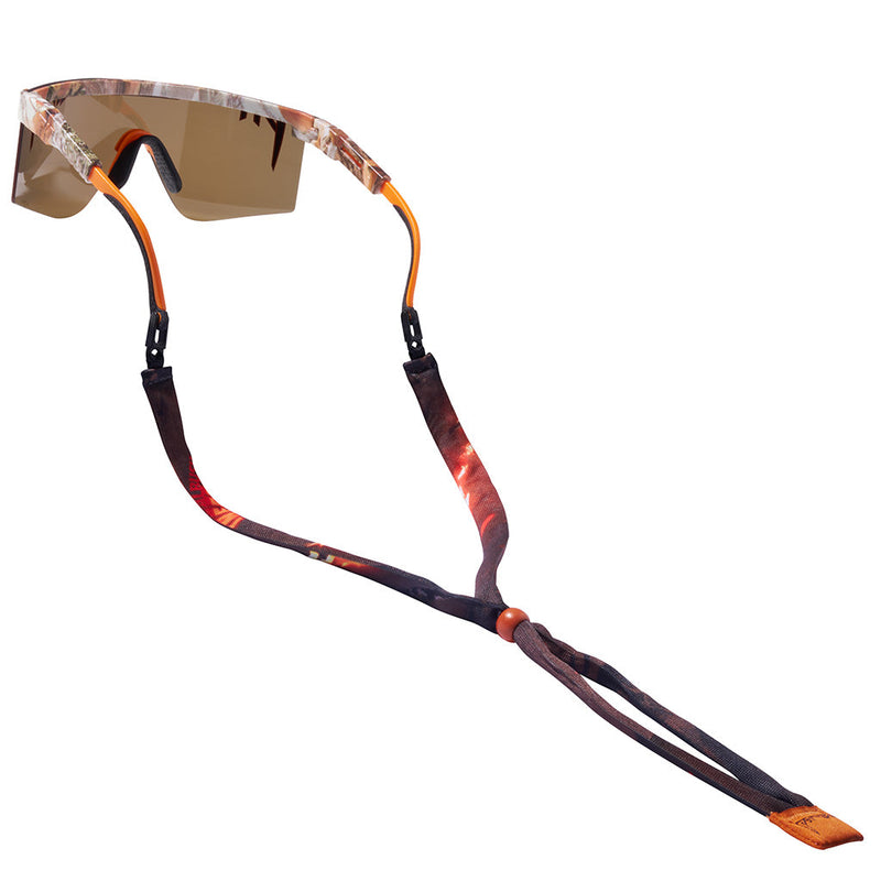 | clips.JPG | Sport sunglasses with a brown and orange camouflage patterned frame, a brown-tinted lens, and an adjustable brown and orange patterned chin strap, shown on a white background.