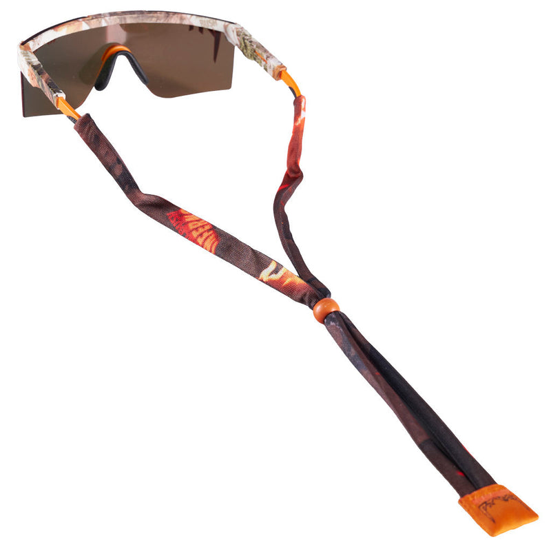 | nice.JPG | Sport sunglasses with a brown and orange camouflage patterned fabric chin strap, orange adjustment sliders, and a brown mirrored lens, shown on a plain white background.