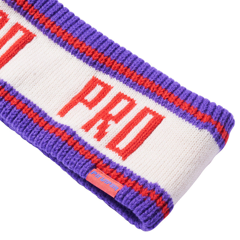 | im_ready_for_my_closeup.JPG | A knitted athletic headband in purple, white, and red, featuring the text 'PRO' in red with 'O' and 'R' on either side. A small red brand tag is visible on the lower right side.